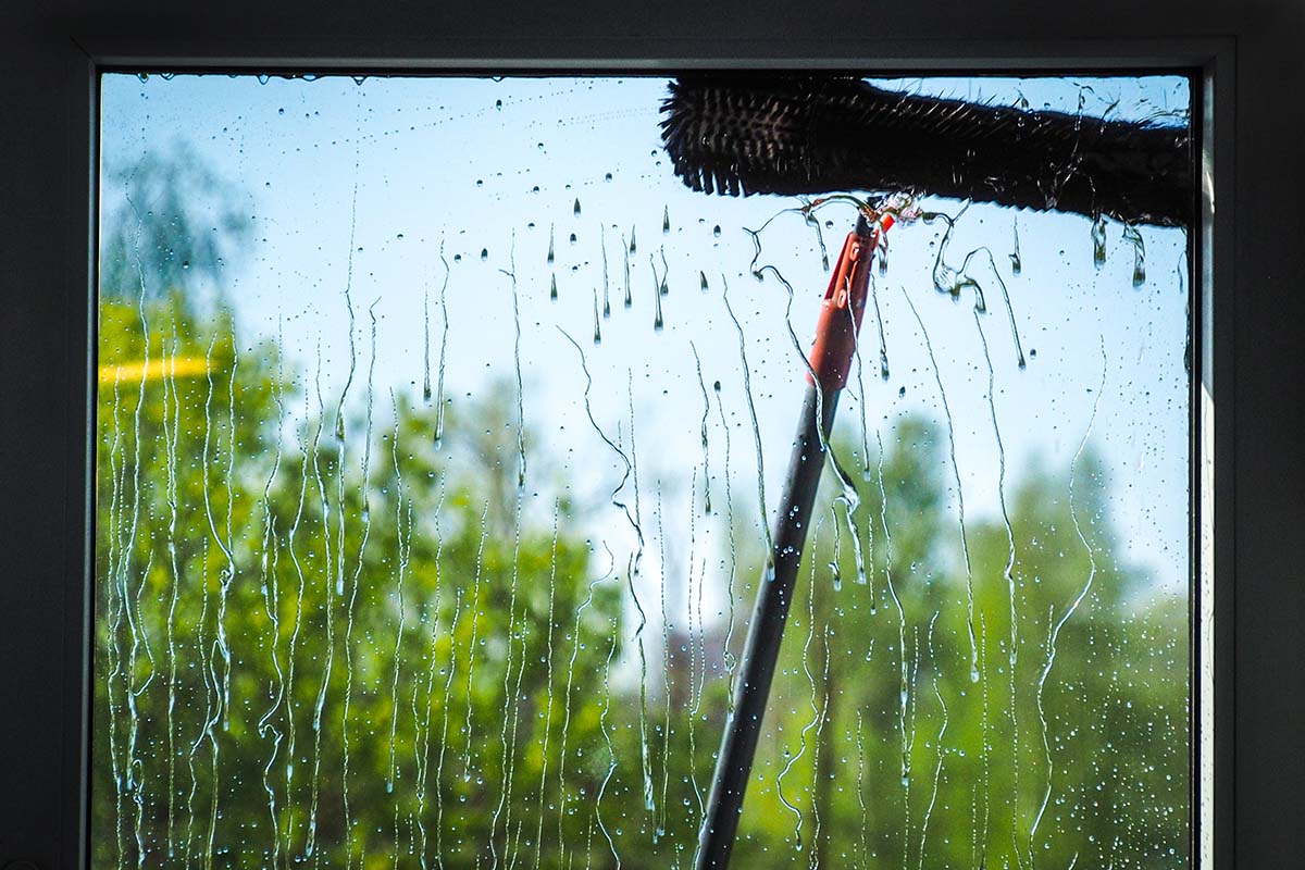 Window cleaning using telescopic water brush and wash system. Wi